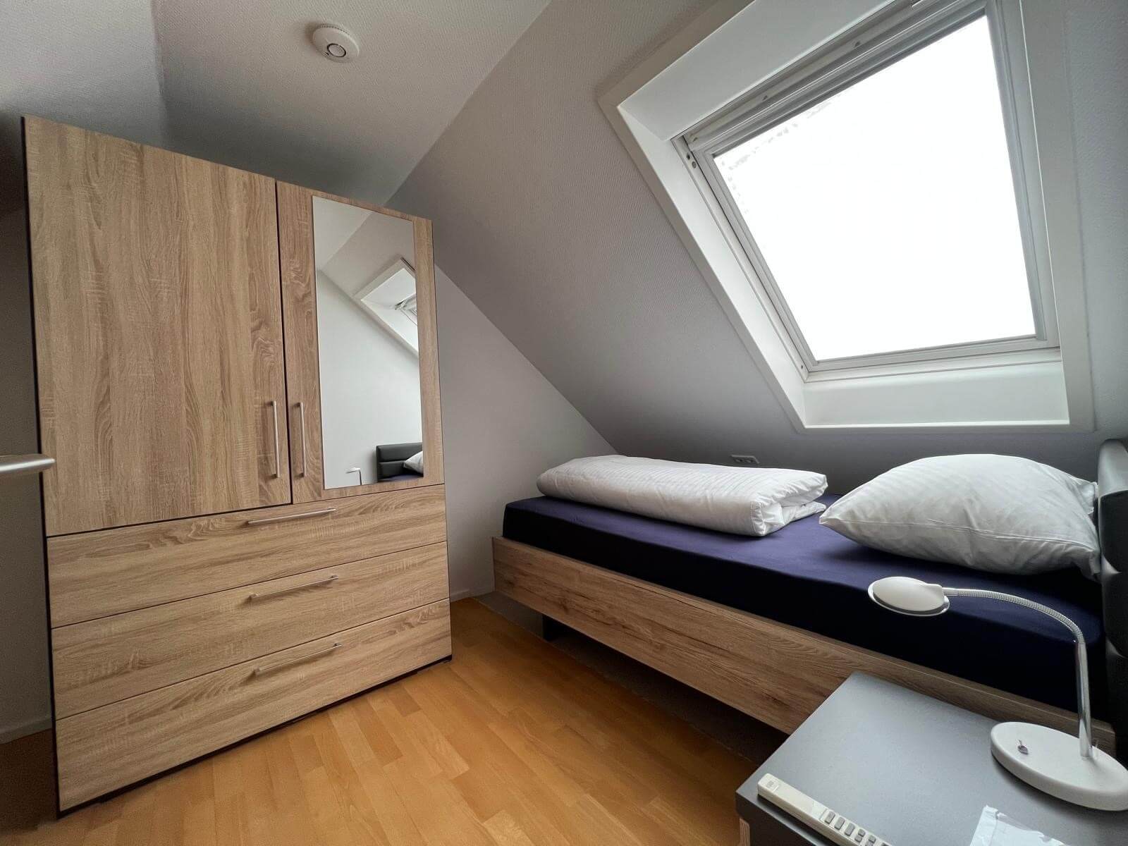 Bett und Schrank im Schlafzimmer der Apartment-Wohnung